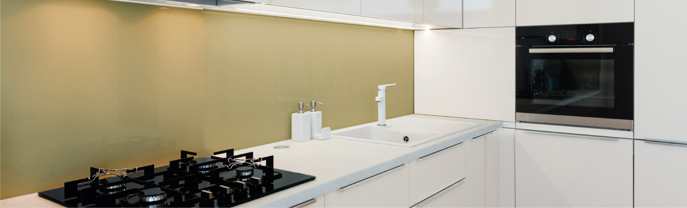Cream glass splashback in a kitchen